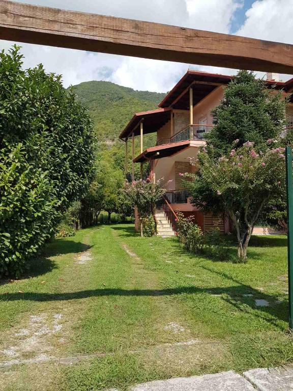 a house with a yard in front of it at Hillside View Home in Kato Loutraki