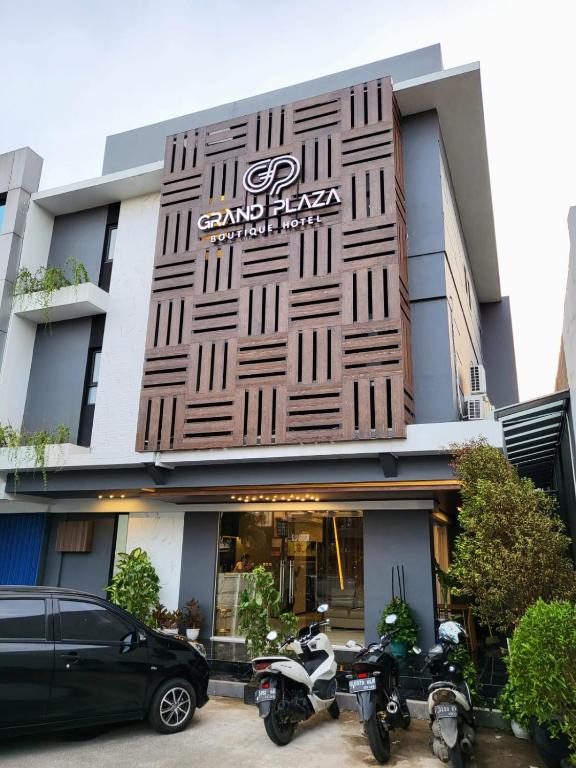 a building with two motorcycles parked in front of it at Grand Plaza Boutique Hotel in Karawang