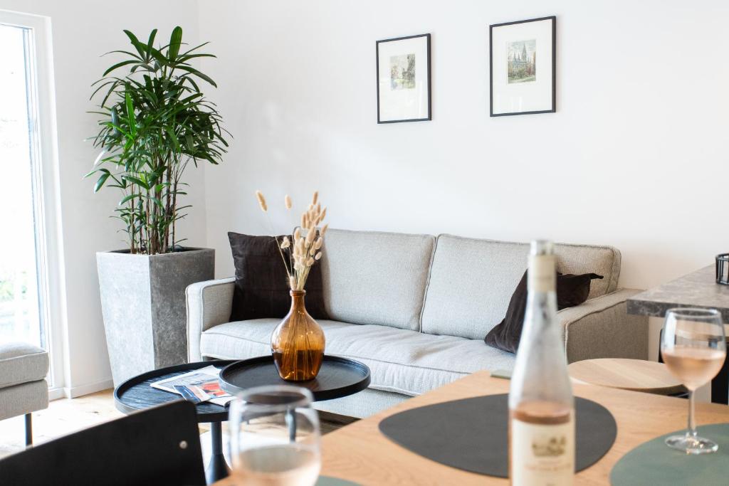 sala de estar con sofá y mesa con copas de vino en Stilvolle Wohnung mit ruhig gelegenem Balkon, en Viena