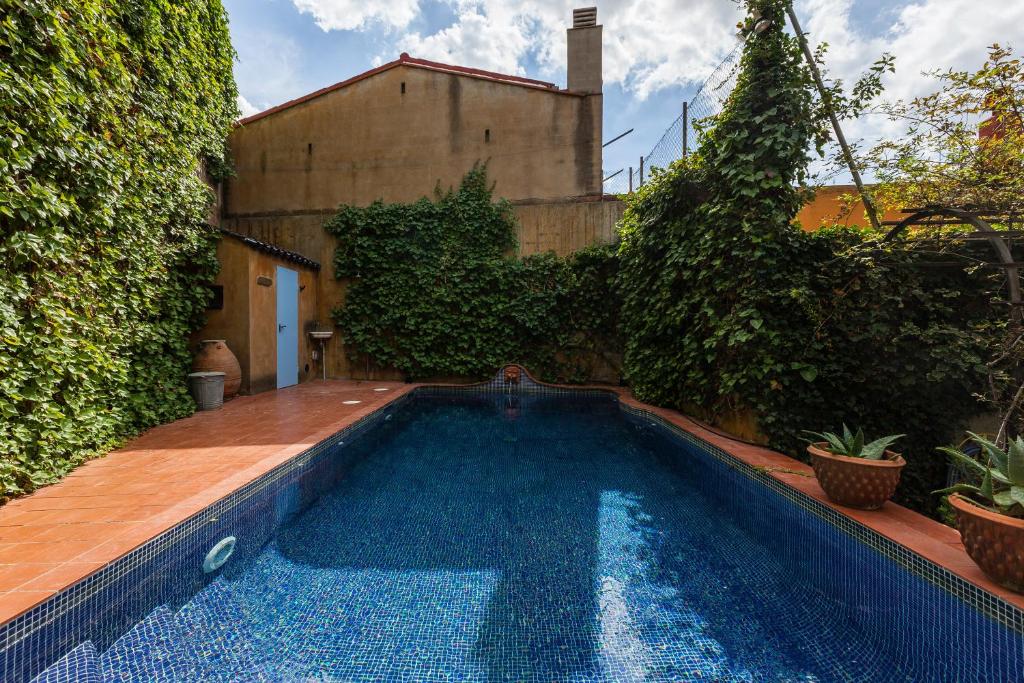 a swimming pool in the backyard of a house at Can Sebrià in Gélida