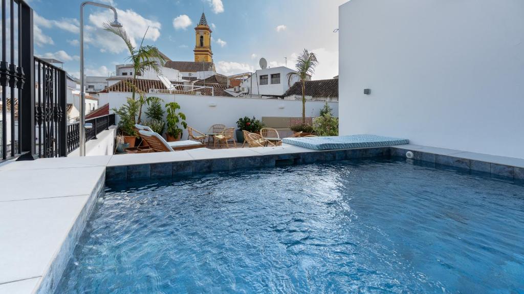 a swimming pool on the side of a house at Veranera Hostel in Estepona