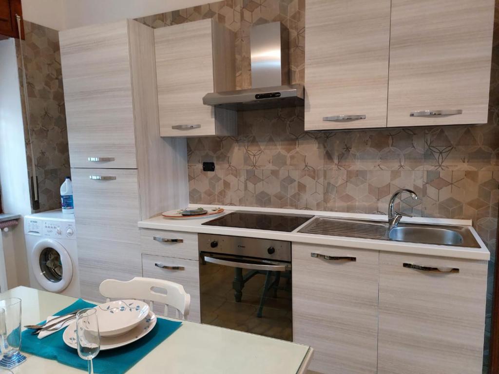 uma pequena cozinha com um lavatório e um fogão em Casa Mami' em Marigliano