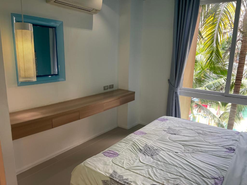 Postel nebo postele na pokoji v ubytování Atlantis Condo Resort Jomtien Beach