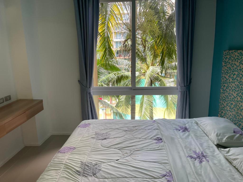 Postel nebo postele na pokoji v ubytování Atlantis Condo Resort Jomtien Beach
