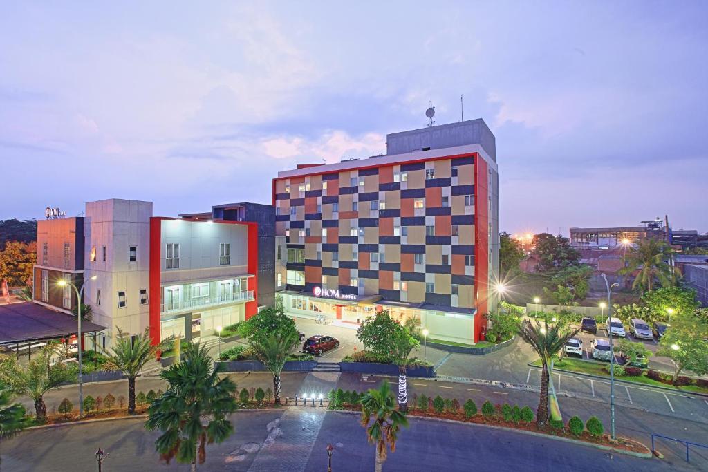 a large building in a city at night at Metland Hotel Bekasi in Bekasi