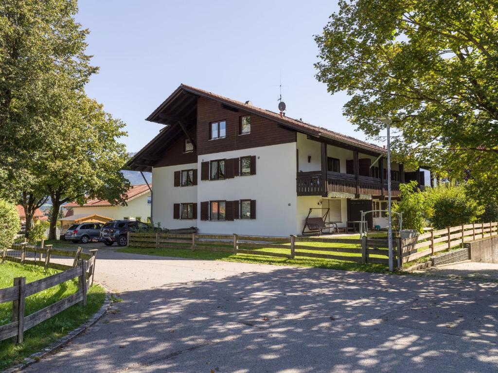 a large white house with a wooden fence at Ferienwohnung Panoramablick in Oberaudorf