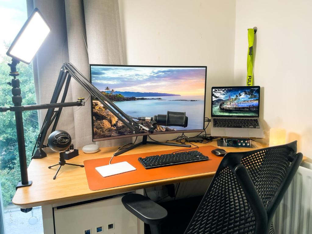 a desk with a computer and a laptop on it at Cosy 1-bedroom apartment in Greater London in London