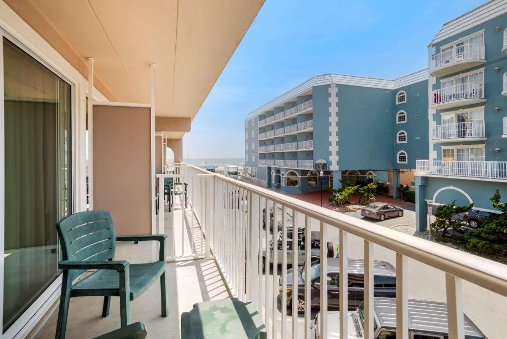 a balcony with chairs and a view of the ocean at Comfort Inn Ocean City Boardwalk in Ocean City