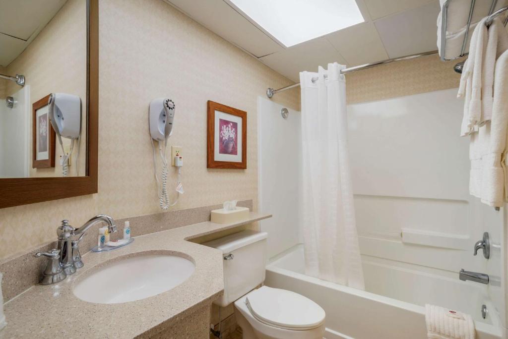 a bathroom with a sink and a toilet and a shower at Comfort Inn Ocean City Boardwalk in Ocean City