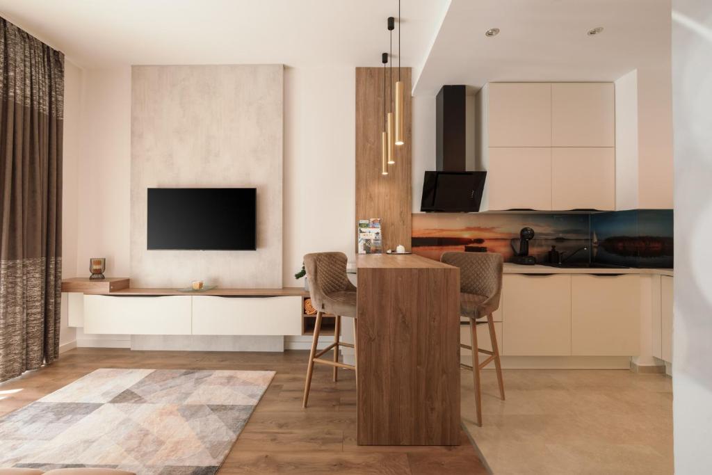 Televiisor ja/või meelelahutuskeskus majutusasutuses Spa Residence Carbona Great Time Apartman