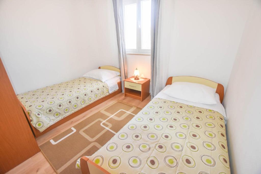 Łóżko lub łóżka w pokoju w obiekcie Apartments Anchor