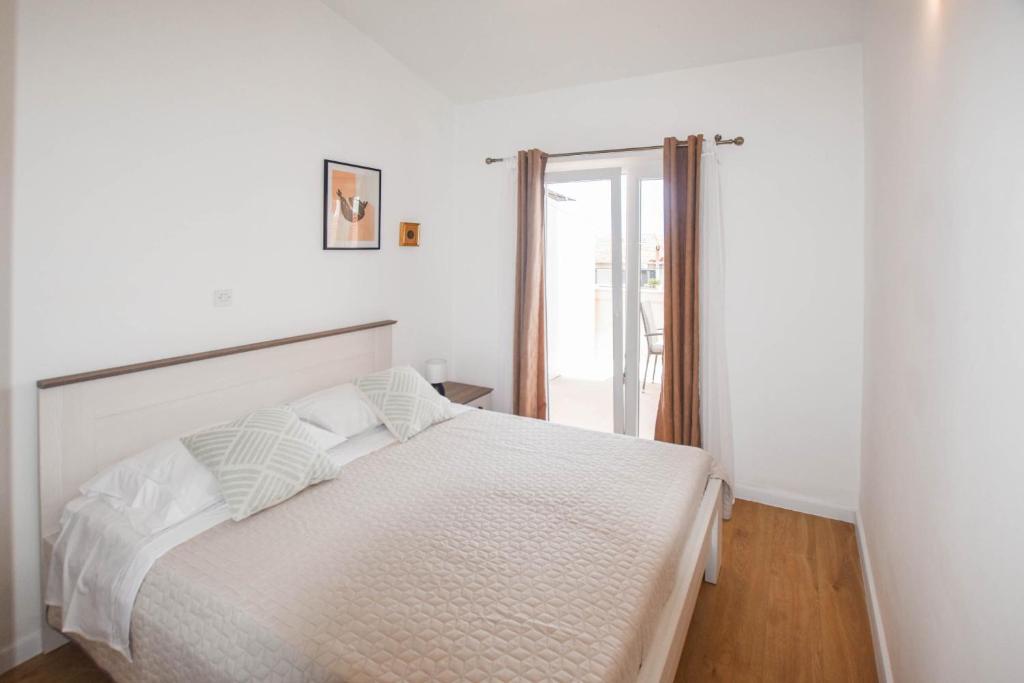 Łóżko lub łóżka w pokoju w obiekcie Apartments Anchor