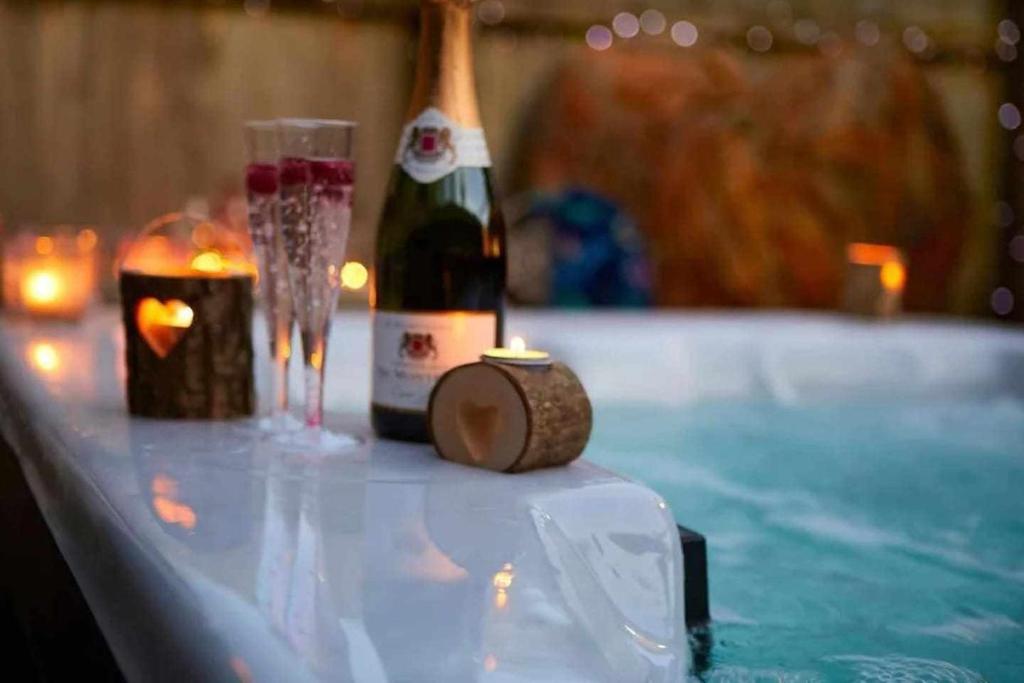 a bottle of champagne and a candle on a table at Entire Home Meloneras BBQ Jacuzzi PoolGolf in Meloneras