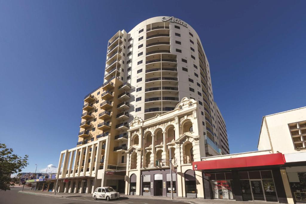 a large building with a large window in front of it at Adina Apartment Hotel Perth Barrack Plaza in Perth