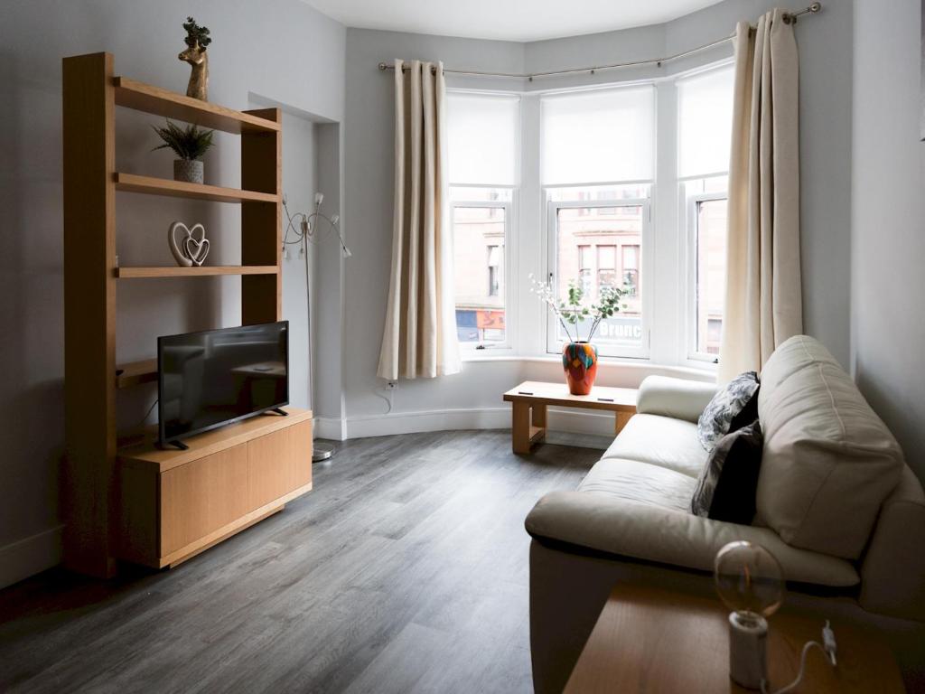a living room with a couch and a television at Pass the Keys Superb 1Bed Flat in Fabulous West End in Glasgow