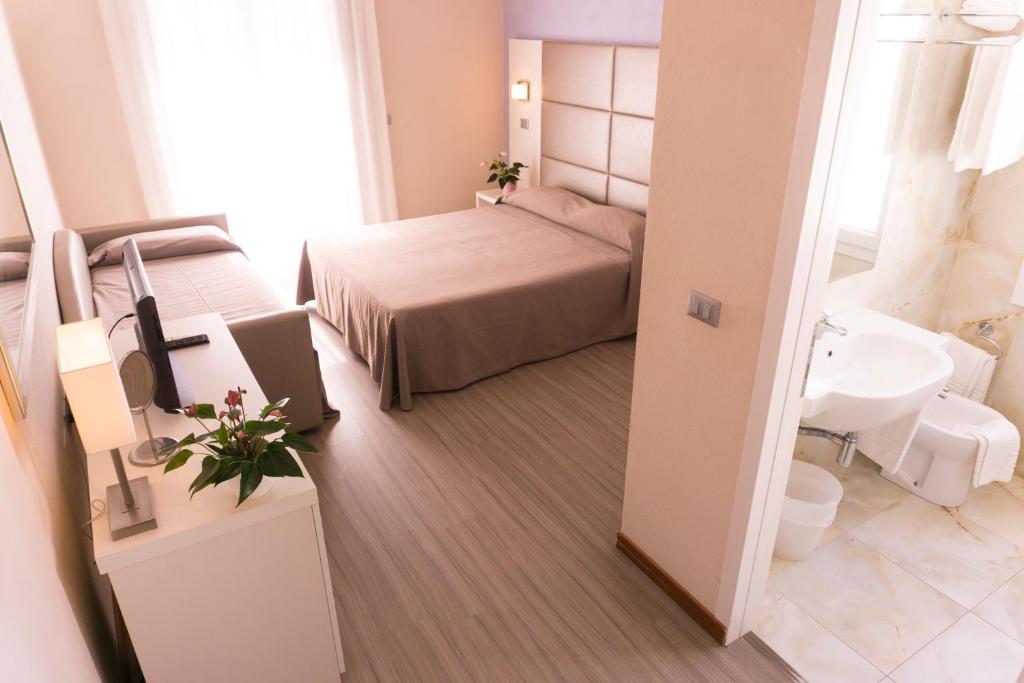 Postel nebo postele na pokoji v ubytování New Hotel Chiari