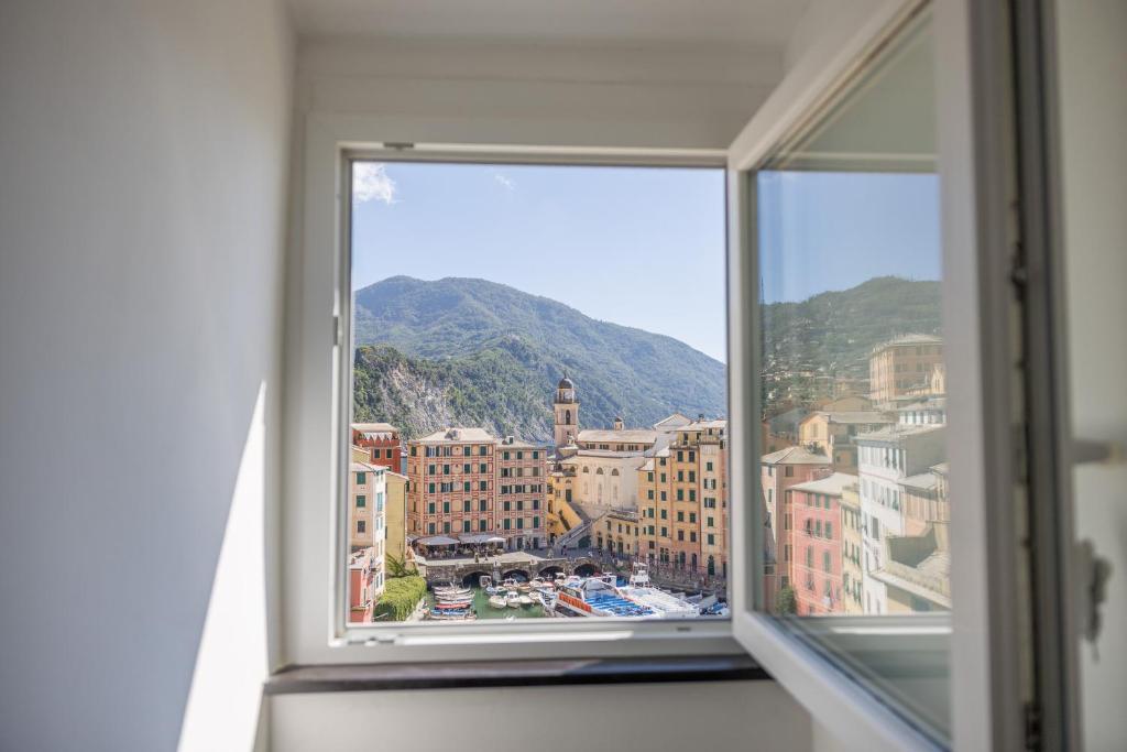 a view of a city from a window at La mansarda sul Porto in Camogli