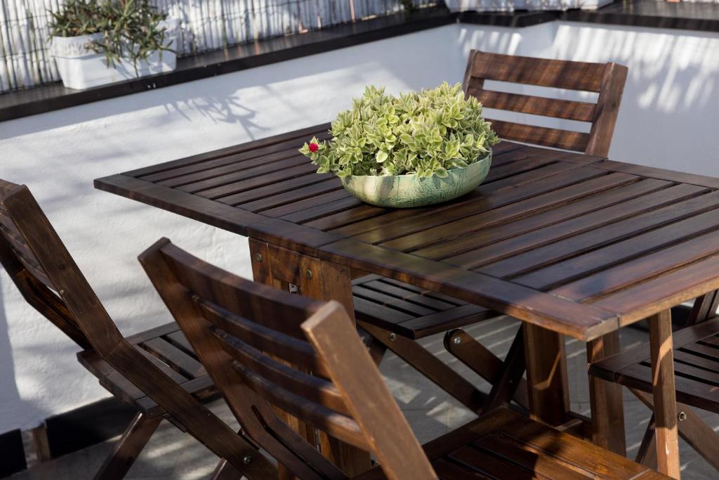 a wooden table with a potted plant on it at La mansarda sul Porto in Camogli