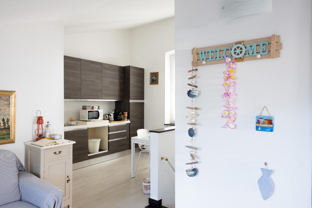a room with a kitchen and a living room at La mansarda sul Porto in Camogli