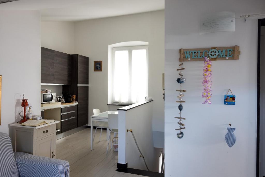 a kitchen and a living room with a refrigerator at La mansarda sul Porto in Camogli