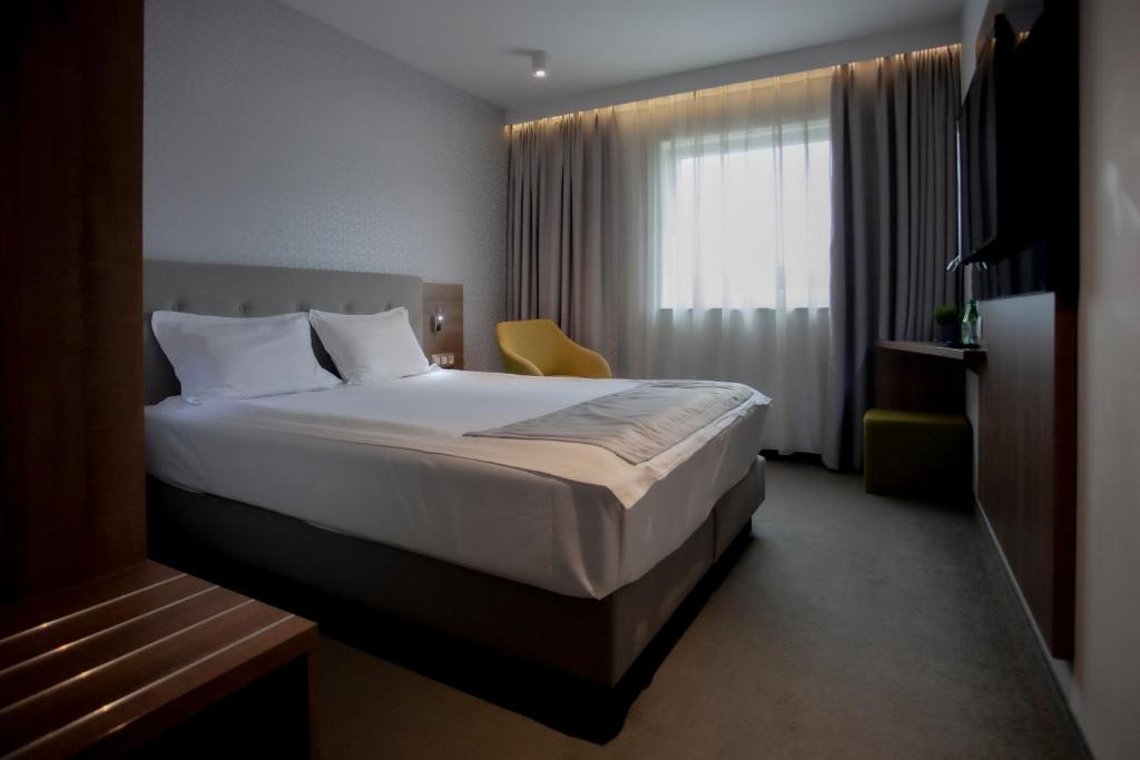 a hotel room with a bed and a window at Abton Hotel in Łódź