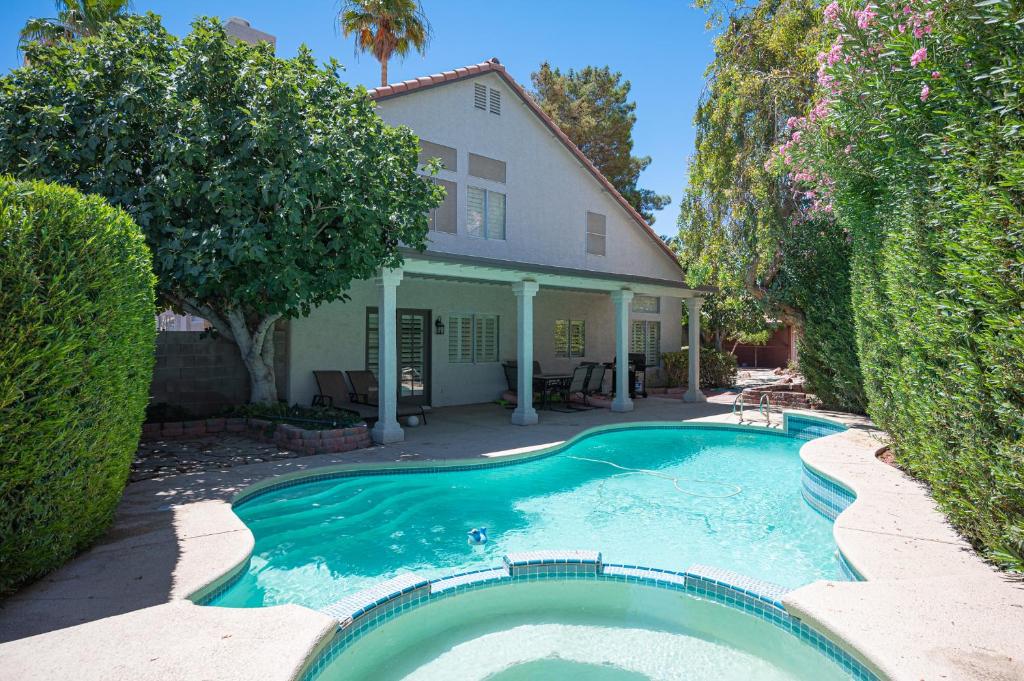 a swimming pool in front of a house at Brilliant 4 Bedroom House With Pool! in Las Vegas
