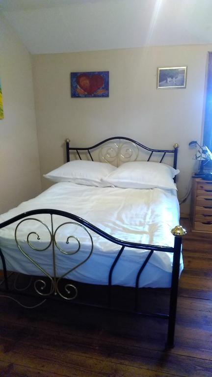 a bedroom with a bed with white sheets and pillows at Altes Bahnerhaus 