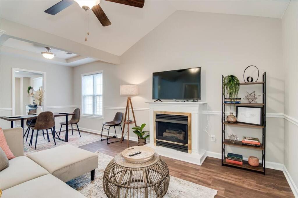 a living room with a couch and a fireplace at The Masters Cottage by Augusta National in Augusta