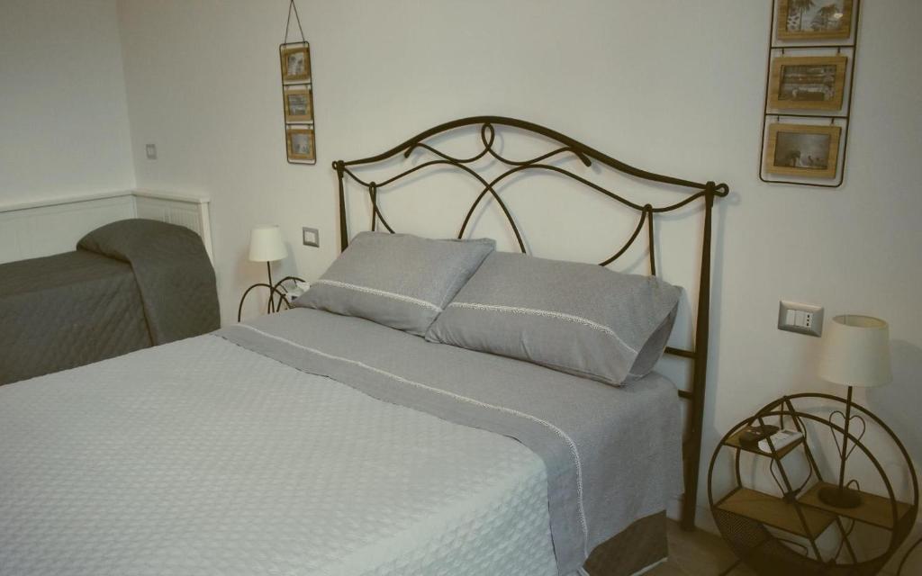 a bedroom with a bed with two pillows on it at Beans Street Affittacamere in Mola di Bari