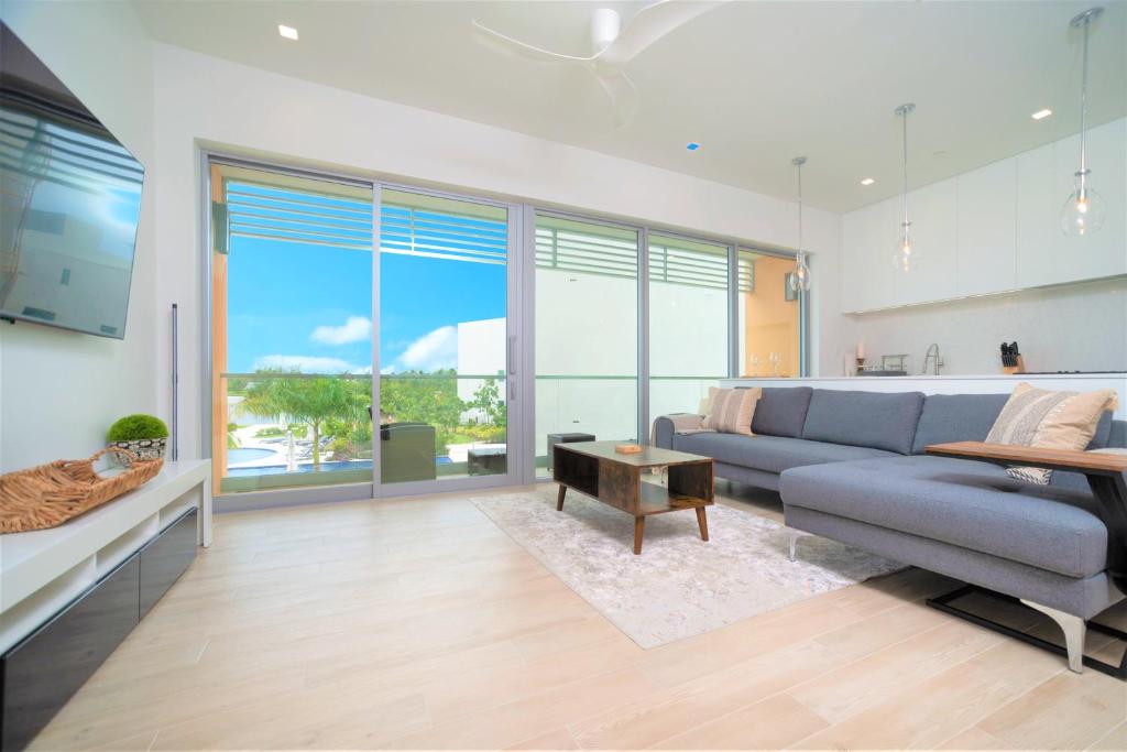 a living room with a couch and a table at Cayman Luxury Rentals at One Canal Point in Upper Land