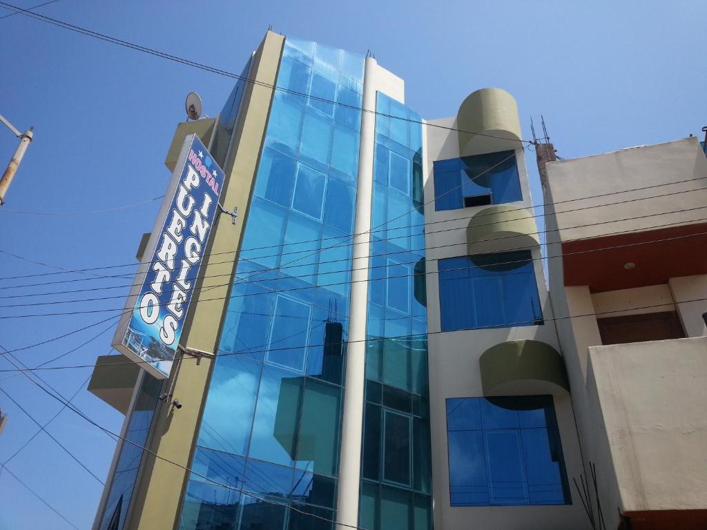 a building with a sign on the side of it at Hostal Puerto Ingles in Ilo