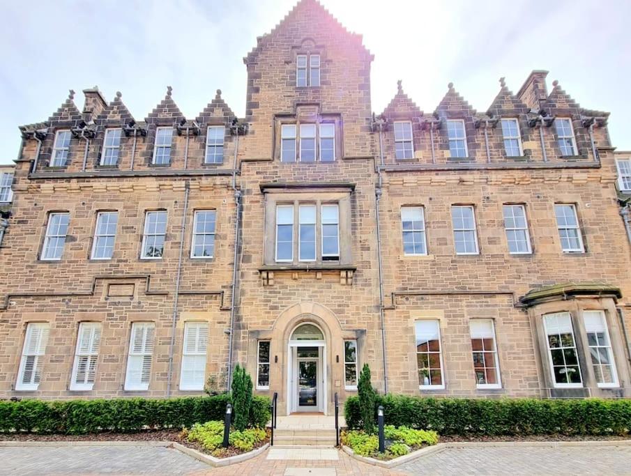 a large brick building with a front door at Unique Two Bed Holiday Home in Edinburgh in Edinburgh