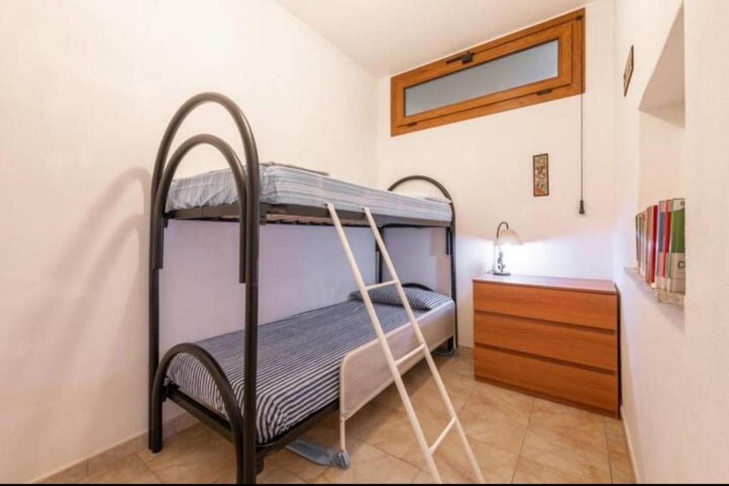 - une chambre avec 2 lits superposés et une commode dans l'établissement Geremeas Country Club, à Torre delle Stelle