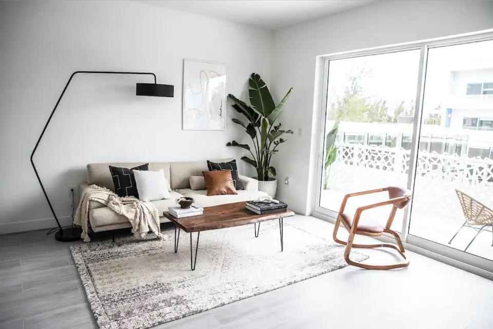 a living room with a couch and a table and a chair at Cayman Luxury Rentals at The Grove in Upper Land