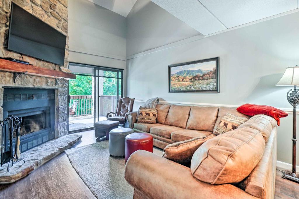 a living room with a couch and a fireplace at Cozy Gatlinburg Condo about 2 Mi to National Park! in Gatlinburg