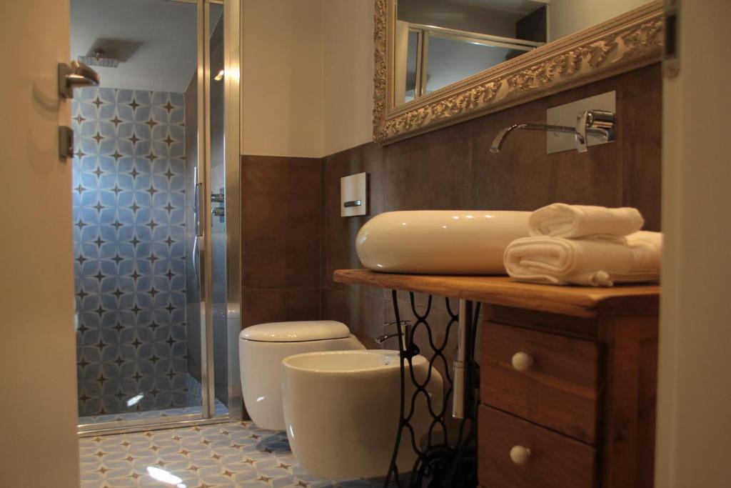 a bathroom with a sink and a toilet and a shower at B&B San Paolo Sweethome in Parma