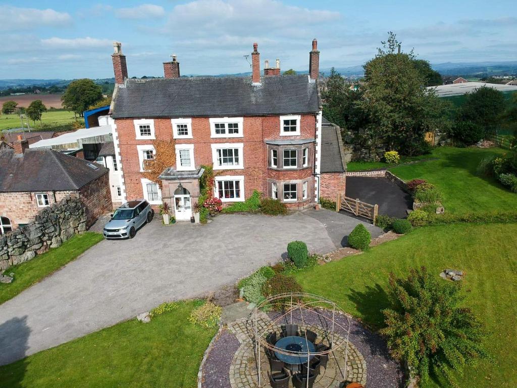an aerial view of a large brick house at Heath View in Cheddleton