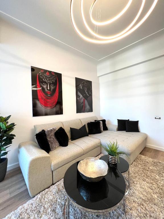 a living room with a couch and a table at Sky View - Luxury Apartament - Sanador Victoriei in Bucharest