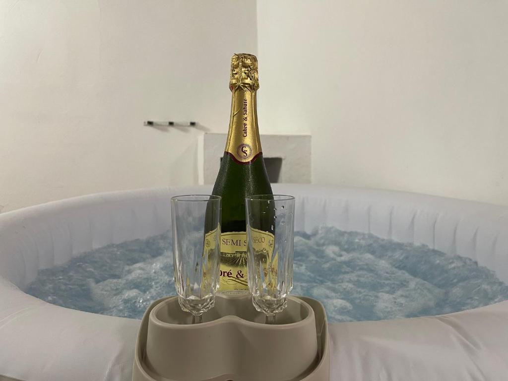 a bottle of champagne and a glass on a table at Monte del Agua House in Erjos