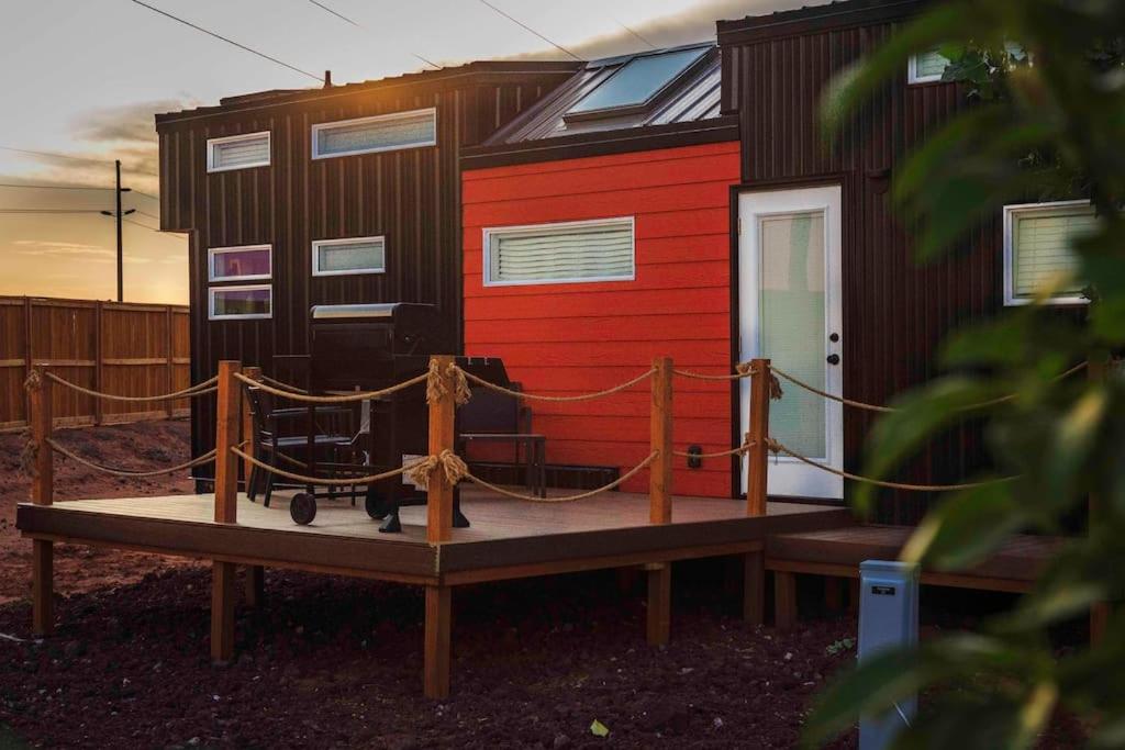 a tiny house on a table in front of a house at Angels Landing Tiny Home in Apple Valley