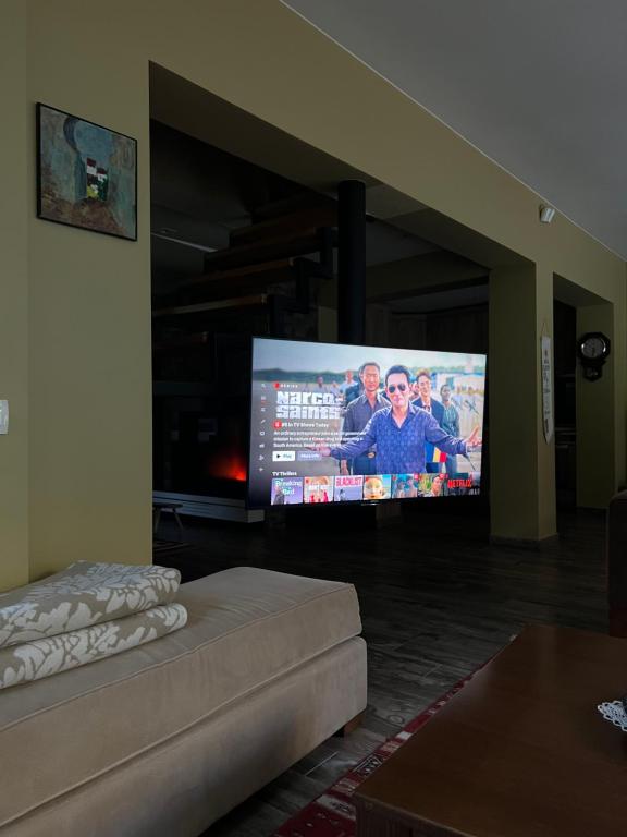 a living room with a large flat screen tv at Brezovica Luxury Villa in Brezovicë