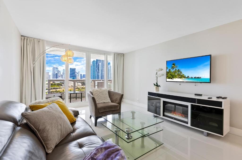 a living room with a couch and a tv at Ocean Utopia in Miami