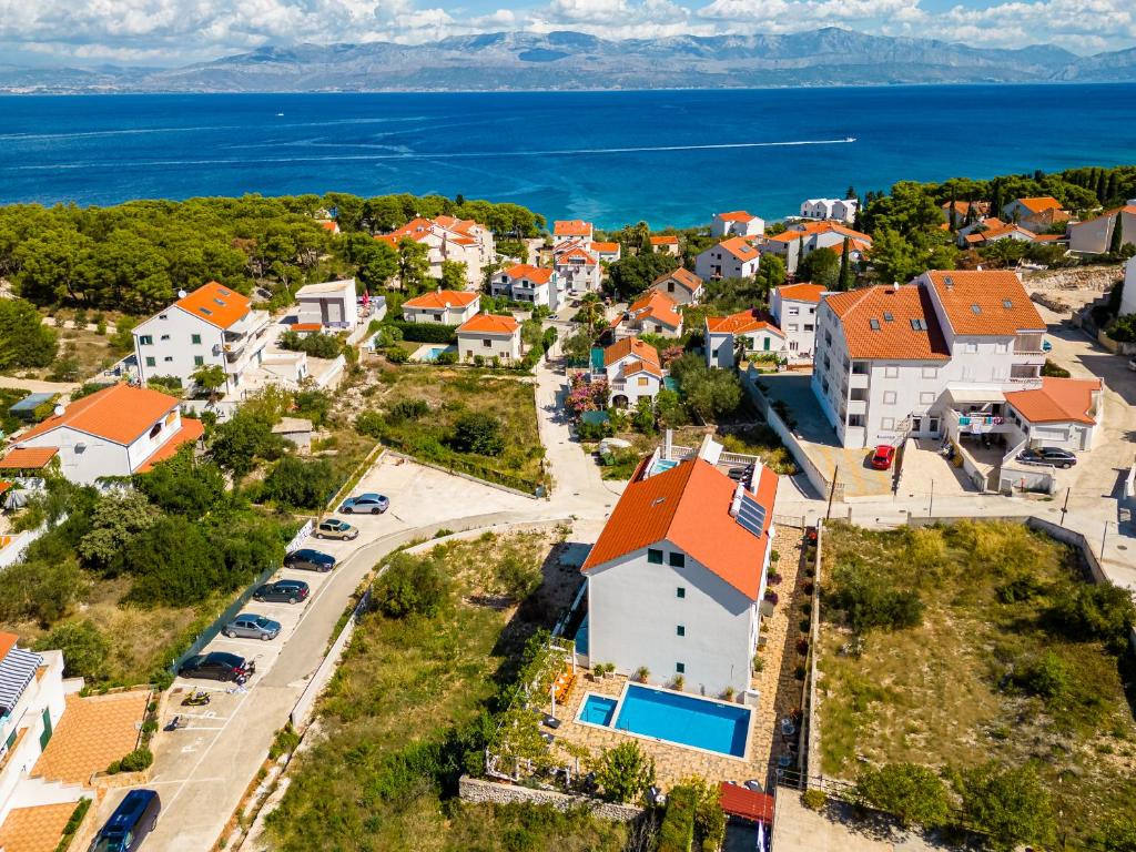 an aerial view of a small town with houses and the ocean at La Perla Apartments in Sutivan