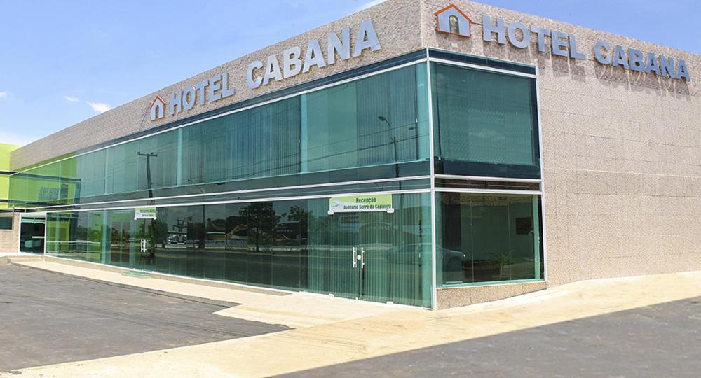 a large building with glass windows in front of it at Hotel Cabana in Teresina