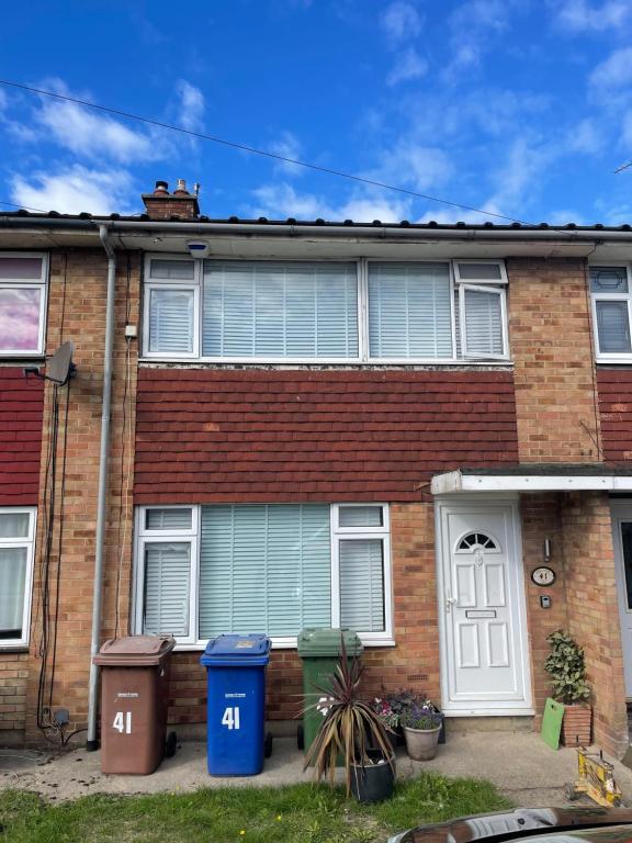 a brick house with two trash cans in front of it at Tilbury Docks Rooms for Short letting in Tilbury