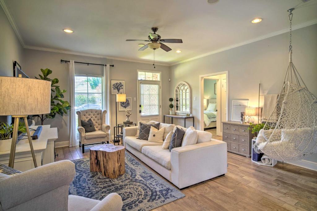 a living room with a white couch and a swing at Baton Rouge Game Day House with Chic Yard Space in Baton Rouge