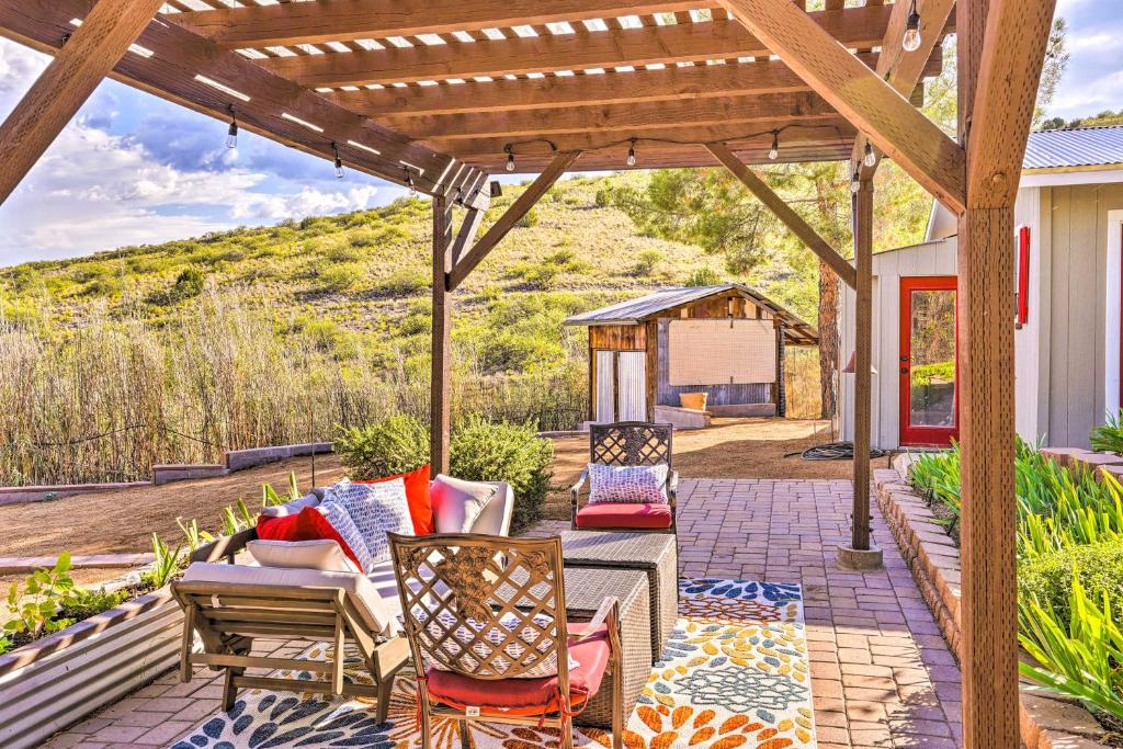a patio with furniture and a wooden pergola at Modern Clarkdale Tiny Home on Mingus Mountain in Clarkdale