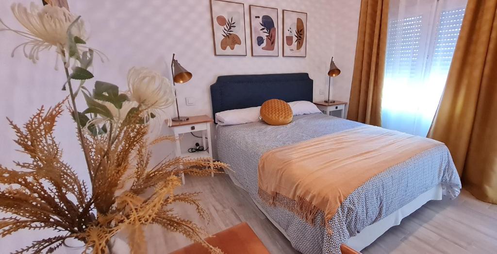 a bedroom with a bed and a plant at El Patio Grande 