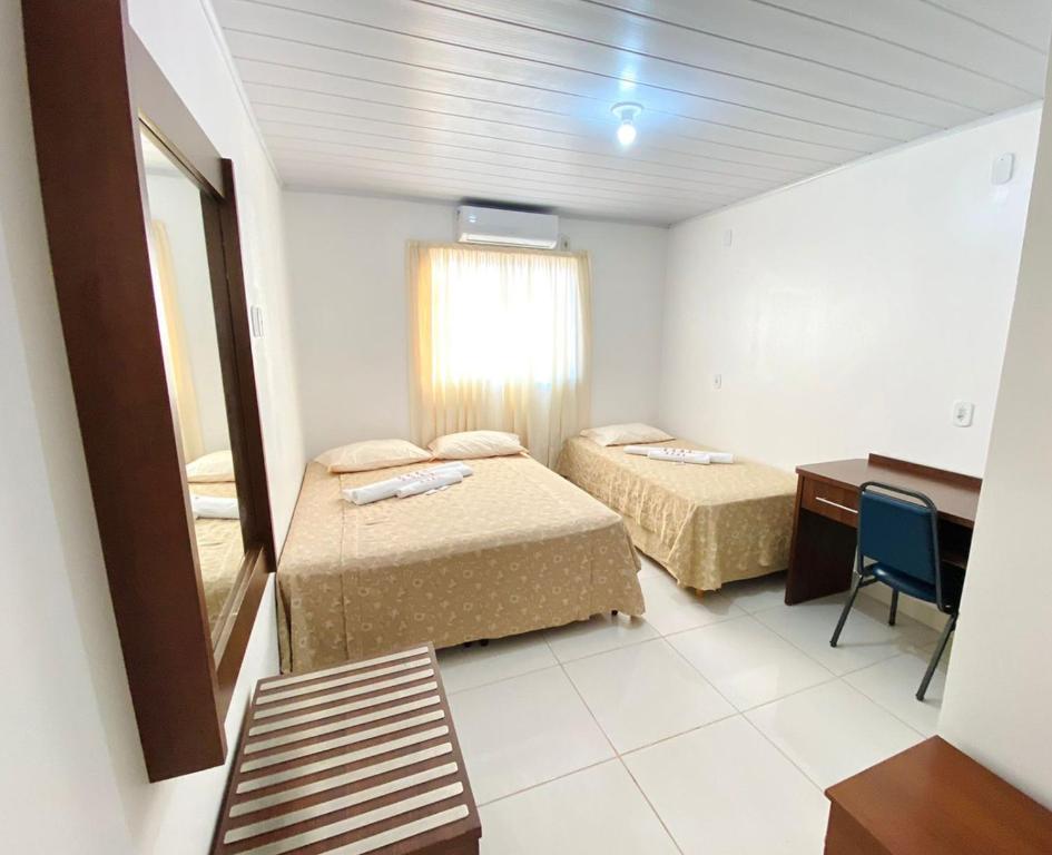 Ένα ή περισσότερα κρεβάτια σε δωμάτιο στο Hotel Alexânia