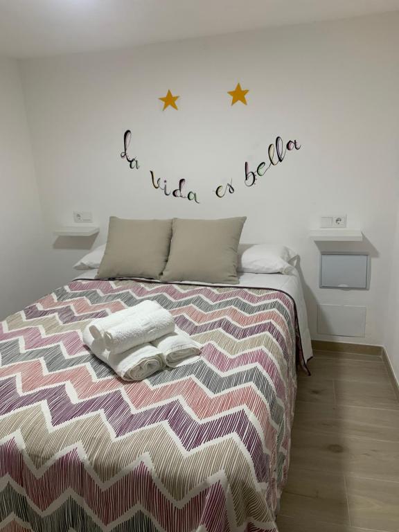 sypialnia z łóżkiem z dwoma ręcznikami w obiekcie La Vida es Bella w mieście Setenil